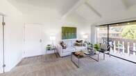 Located in Irvine, CA, this well-appointed 1-bedroom, 2-bathroom home offers a thoughtfully designed single-floor layout. The living room immediately impresses with its vaulted, exposed-beam ceilings that lend an open, airy character to the space. Large sliding glass doors flood the room with natural light and lead directly to a private outdoor balcony, offering pleasant views of the surrounding greenery. Wood-look flooring flows through the main living areas, complementing the clean, bright white walls throughout.

The galley-style kitchen features white cabinetry with ample storage, granite-style countertops, a double stainless steel sink, and a full suite of white appliances, all thoughtfully arranged for efficient use of space.

The bedroom is generously sized, featuring soft carpeting, a large window with exterior views, and easy access to a dedicated closet. Two full bathrooms serve the home — one featuring an extended vanity with a granite-style countertop, white cabinetry, and wood-look flooring, while the second offers a clean, functional layout with a shower-tub combination. Together, the rooms create a cohesive, comfortable living environment suited for everyday life in one of Southern California's most desirable communities.