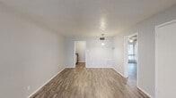 Located at 531 S Belt Line Rd in Grand Prairie, TX, this one-bedroom, one-bathroom unit is thoughtfully laid out across a single floor. The interior is finished with wood-style plank flooring throughout, set against neutral gray walls and white trim, creating a clean and consistent aesthetic.

The combined living and dining area offers an open, functional layout. The living space features a large window that invites natural light and includes a ceiling fan, while the dining area is highlighted by a pendant light fixture. A textured ceiling adds subtle character to both spaces.

The kitchen is efficiently arranged in a galley-style configuration, featuring white cabinetry, dark laminate countertops, a double-basin sink, and black appliances including a refrigerator, electric range, and dishwasher. Wood-style flooring continues seamlessly from the main living areas into the kitchen.

The bedroom is a comfortable, well-proportioned room with the same warm flooring and neutral walls, offering a calm and private retreat. Two closets provide practical storage throughout the unit.

The bathroom includes a full tub and shower combo with white tile surround and brushed nickel fixtures, maintaining the clean, understated design found throughout the home. The overall layout is efficient and well-suited for single occupancy or a couple seeking a straightforward living space.