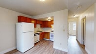 Located at 691 Tehama Ave in Hayward, CA, this 2-bedroom, 1-bathroom unit offers a compact and efficient single-floor layout designed to maximize every square foot. The interior features consistent wood-style laminate flooring throughout, lending a warm and cohesive look across all rooms.

The kitchen is equipped with warm-toned wooden cabinetry arranged in an L-shaped configuration, offering ample storage space. White appliances — including a refrigerator, gas range, and dishwasher — complement the cabinetry, while a ceiling-mounted light fixture provides focused illumination over the workspace.

Both bedrooms are bright and cleanly finished with white walls and natural light from sliding windows that offer views of the surrounding neighborhood. Each bedroom features a built-in sliding-door closet with gold-tone hardware, providing practical storage solutions.

The bathroom is well-appointed with a full-size soaking tub and tiled shower surround, a toilet, and a vanity with a wooden base. Wood-style flooring continues into the bathroom, maintaining design consistency throughout the unit.

The overall ambiance of the space is clean, functional, and move-in ready, with a neutral color palette that allows for easy personalization.