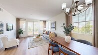 Located in San Diego, CA, this well-appointed 2-bedroom, 3-bathroom single-floor residence offers a thoughtfully designed layout with a comfortable, modern aesthetic. The open-concept living and dining area is bathed in natural light from large windows and French doors that lead to a private balcony, creating a bright and welcoming atmosphere. Light-toned hardwood-style flooring flows throughout the main living spaces, adding warmth and cohesion to the design.

The kitchen is equipped with dark espresso cabinetry, stainless steel appliances, a spacious peninsula with a white countertop, and pendant lighting — combining functionality with style. The adjacent dining area features a chandelier overhead and a window with outdoor views, making it an inviting space for meals.

Both bedrooms are carpeted and generously proportioned, offering tranquil retreats with ample natural light. The primary bedroom is well-sized and connects to an en-suite bathroom and a large walk-in closet outfitted with extensive built-in shelving and hanging rods. The bathrooms are finished with dark vanity cabinetry, marble-style tile surrounds in the tub/shower, and framed mirrors. A convenient hallway connects all areas, completing this well-organized and comfortable San Diego home.