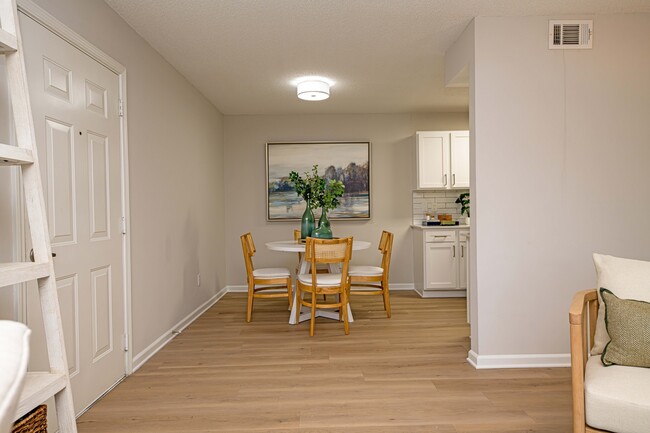 Dining room with hardwood-style flooring - The Collins Apartment Homes