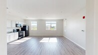 Located at 1800 S 22nd Ave in Bozeman, Montana, this two-bedroom, two-bathroom unit offers a well-designed, single-level floor plan with a comfortable and functional layout. The open-concept kitchen and living area serves as the heart of the home, bathed in natural light streaming through multiple large windows that frame views of the surrounding Montana landscape and mountains. The living area features light-toned hardwood-style flooring that extends throughout the main spaces, lending a clean and cohesive aesthetic. The kitchen is equipped with white shaker-style cabinetry, granite-look countertops, and black stainless steel appliances including a refrigerator, range, built-in microwave, and dishwasher. Both bedrooms are carpeted and generously sized, with the primary bedroom offering a spacious walk-in closet fitted with wire shelving systems for ample storage. The second bedroom also includes closet access. Each bathroom features a tub-shower combination, a vanity, and wood-look vinyl flooring. Neutral tones throughout the unit create a bright, move-in-ready atmosphere. With its modern finishes, natural light, and scenic Montana views, this Bozeman residence offers a practical and appealing living environment.