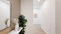 Located in Chicago's vibrant River North neighborhood, this 1-bedroom, 1-bathroom residence offers a thoughtfully designed layout with contemporary finishes throughout. The entryway sets a welcoming tone with warm neutral-toned walls, light wood flooring, and recessed lighting that carries through the entire unit.

The open-concept living room and kitchen area is a true highlight, boasting expansive floor-to-ceiling windows framed in sleek black that flood the space with natural light and deliver sweeping views of the Chicago skyline, including iconic landmarks. The living area offers generous proportions, while the kitchen features stainless steel appliances, glossy white cabinetry, and direct access to the same dramatic cityscape.

The spacious primary bedroom continues the floor-to-ceiling window theme, offering breathtaking elevated city views, a double-door closet, and a calming accent wall. Light wood flooring ties the rooms together cohesively.

The bathroom is finished in a modern style with warm wood cabinetry, a white quartz countertop, an illuminated mirror, and clean tile flooring. Throughout the residence, the design balances a bright, airy aesthetic with high-end urban sophistication, making it an ideal home in the heart of Chicago.