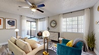 Located in Gilbert, Arizona, this 2-bedroom, 2-bathroom residence offers a thoughtfully designed single-story layout that balances comfort and contemporary style. The living room serves as the heart of the home, featuring wood-look flooring, a ceiling fan, textured ceilings, and large windows with sliding patio door access that fill the space with natural light and provide outdoor views. The open dining area flows seamlessly from the living room, offering an intimate space accented by neutral tones and additional window light. The kitchen is equipped with stainless steel appliances, two-tone cabinetry featuring white upper and gray lower cabinets, white quartz countertops, and wood-look tile flooring — all beneath a tray ceiling detail that adds architectural interest. The spacious primary bedroom features plush carpeting, generous natural light, and a dedicated walk-in closet. The second bedroom is equally comfortable with carpeted flooring and bright window exposure. Both bathrooms are clean and well-finished, with one featuring a full soaking tub and shower combination alongside wood-look flooring. Each bedroom includes its own closet for ample storage. The overall ambiance throughout is modern and inviting, with consistent finishes tying each room together cohesively.