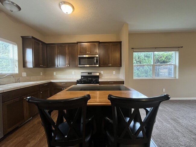 Building Photo - Light-Filled Home Featuring Island Kitchen, Fireplace & Two-Car Garage