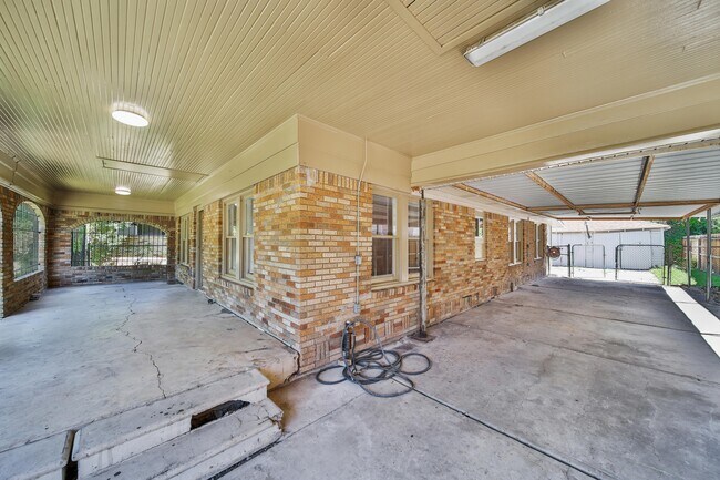 View of the patio and carport. Separate detached garage in the back. - 1409 Pearson St