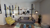This well-appointed 1-bedroom, 1-bathroom unit is thoughtfully designed with a single-floor, open-concept layout that maximizes functional living space. The living area serves as the heart of the home, showcasing an artistic accent wall composed of vertical wood and painted panels in navy, white, and yellow-green tones, complemented by a bold canvas artwork. Wood-look flooring runs throughout, adding warmth and visual continuity across all rooms. A ceiling fan overhead enhances comfort in the living space.

The kitchen is a standout feature, offering dark espresso cabinetry, granite countertops, stainless steel appliances including a range, microwave, and refrigerator, and a double-basin sink. The galley-style layout provides ample counter and storage space, with pendant lighting adding a refined touch.

The bedroom is generously proportioned, featuring a ceiling fan, large windows dressed with sheer curtains that allow natural light to filter in, and direct access to a walk-in closet. The bathroom includes a full soaking tub and shower combination with clean white tile surround. Every room reflects a cohesive, contemporary aesthetic with vibrant accent colors woven throughout the décor.