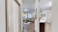 Located at 100 Spadeleaf Boulevard in Hendersonville, TN, this 2-bedroom, 2-bathroom single-story home offers a thoughtfully designed layout with modern finishes throughout. The open-concept living room features wood-style flooring, large windows with sheer curtains, and a sliding glass door that fills the space with natural light. The adjacent dining area continues the bright, airy feel with additional windows and track lighting overhead. The kitchen is well-appointed with dark espresso cabinetry, white countertops, stainless steel appliances, and wood-style flooring, offering both style and functionality. The primary bedroom is a comfortable retreat featuring plush carpet, ceiling fan, and large windows with outdoor views. The second bedroom mirrors this inviting aesthetic with a bold accent wall and ample natural light. Both bathrooms include dark wood vanities with white countertops, a tub-shower combination, and wood-style tile flooring. A dedicated in-unit laundry room houses a full-size washer and dryer. Two closets provide generous storage throughout the home. The overall ambiance is warm, modern, and well-lit, making this a practical and comfortable residence in the heart of Hendersonville.