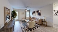 Located at 5250 Highway 138 in Union City, Georgia, this well-appointed 2-bedroom, 2-bathroom residence delivers a comfortable and functional single-floor layout. The open living room is a standout feature, showcasing light-toned hardwood-style flooring, a ceiling fan with integrated lighting, and large windows with exterior door access that flood the space with natural light. The living area flows seamlessly, providing ample room for both relaxing and entertaining.

The kitchen is equipped with white cabinetry, granite-style countertops, a tile backsplash, and black appliances including a range and dishwasher, combining practicality with a clean aesthetic.

Both bedrooms are generously proportioned, featuring plush wall-to-wall carpeting, ceiling fans, and windows dressed with curtain panels. The primary bedroom offers a notably spacious footprint with a dedicated closet. Each bedroom is served by its own full bathroom, both featuring tiled soaking tub and shower combinations with crisp white finishes — one with hardwood-style flooring and the other with classic tile.

Two closets provide solid storage solutions, including a walk-in with wire shelving. Connecting hallways keep the layout efficient and accessible. Overall, this residence offers a bright, comfortable atmosphere suited for everyday living.