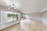 Located at 832 Packard St in Ann Arbor, Michigan, this two-bedroom, one-bathroom unit offers a practical and well-appointed single-floor layout. The open-plan living and dining area is bright and airy, featuring light wood-look tile flooring and large windows that frame views of the surrounding neighborhood. A sliding glass door connects the living space directly to a private balcony, extending the sense of openness and providing pleasant outdoor views of the tree-lined street.

The kitchen is a standout feature, outfitted with rich, dark wood cabinetry, granite countertops, a subway tile backsplash, and full appliances — delivering both style and functionality in a compact footprint.

The two bedrooms are comfortably sized and finished with the same light-toned flooring found throughout the unit. The primary bedroom benefits from a large window that brings in natural light and neighborhood views, while both bedrooms include closet storage. One bedroom features a mirrored sliding-door closet for added convenience.

The bathroom is clean and well-finished, offering a tiled tub-shower combination, a granite-topped vanity, and modern fixtures. A hallway connects the main living areas to the private quarters, completing this efficiently designed and move-in ready Ann Arbor residence.