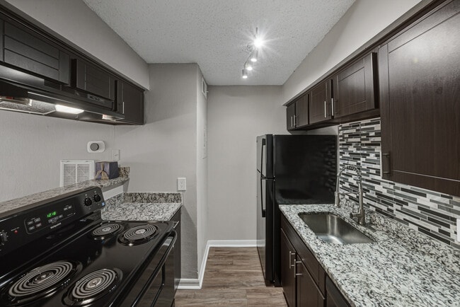 Modern apartment kitchen with updated finishes and appliances - Magnolia Apartments