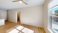 Located at 900 3rd St SE in Cedar Rapids, Iowa, this well-appointed 2-bedroom, 2-bathroom single-floor residence offers a thoughtfully designed open layout. The combined kitchen and living area serves as the heart of the home, featuring a large peninsula with a double sink and white quartz-style countertops, white shaker cabinetry, stainless steel appliances including a refrigerator, range, and built-in microwave, and recessed lighting accented by pendant lights. Light hardwood-style flooring runs throughout the main living areas, enhancing the bright and clean aesthetic. The primary bedroom is a generous space with hardwood-style floors, a ceiling fan, and direct access to its own bathroom and a walk-in closet outfitted with multi-tiered wire shelving systems. The second bedroom features plush carpeting, a ceiling fan, and a window with exterior views, offering a comfortable and well-lit retreat. Both bathrooms are finished with white vanities featuring brushed nickel hardware and tub-shower combinations. Hallways connect the spaces with ease, and the overall palette of warm neutral tones throughout creates a cohesive, move-in-ready ambiance suited for a variety of lifestyles.