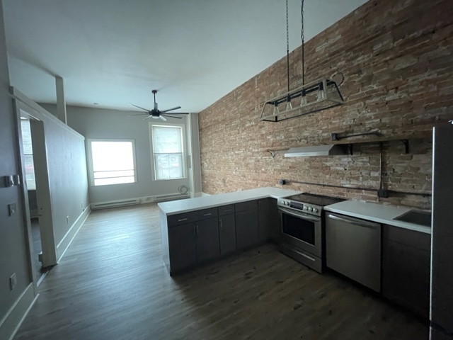 high 11' ceilings and large windows, new floors brick exposed walls - 83 Main St