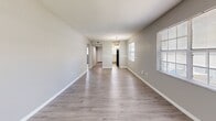 Located at 2002 Colonial Parc Dr in Tampa, FL, this single-floor, 3-bedroom, 2-bathroom unit offers a practical and well-appointed layout. Light-toned wood-look flooring runs throughout the home, complementing neutral gray walls and clean white trim for a cohesive, modern aesthetic. Textured ceilings add character to each room.

The open living and dining area is bright and spacious, with multiple windows allowing ample natural light and views of the surrounding greenery. The kitchen features white shaker-style cabinetry, light granite-style countertops, a stainless sink, and black appliances, with a window above the sink bringing in additional light.

The generously sized primary bedroom offers a large window with outdoor views, while the additional bedrooms are well-proportioned, each with access to natural light. One bedroom includes a double sliding-door closet for added storage.

Both bathrooms are finished cleanly in white, with shaker-style vanities, white countertops, and wood-look flooring. One bathroom features a full tub-shower combination with white tile surround, while the second provides a bright vanity with a framed mirror and overhead lighting. Two hallways connect the layout efficiently, completing this functional and neatly presented Tampa residence.