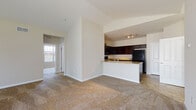 Located at 1802 Kelly's Path in Reynoldsburg, Ohio, this single-floor home offers a thoughtfully designed layout with a clean, neutral aesthetic throughout. The open-concept living area is anchored by vaulted ceilings and plush carpeting, creating a bright and spacious feel that flows seamlessly into the kitchen. The kitchen is well-equipped with rich dark cabinetry, granite-style countertops, a peninsula with a sink, and black appliances including a refrigerator, range, and over-the-range microwave. Tile flooring grounds the kitchen space, which is illuminated by track lighting overhead. Bedrooms feature soft carpeting and generous closet space, including a large walk-in closet outfitted with wire shelving and hanging rods. The primary bathroom includes a dark vanity with a stone-look countertop, tile flooring, accessibility grab bars, and a glass-enclosed shower. A dedicated laundry area with washer and dryer hookups adds everyday convenience. The attached two-car garage provides ample storage and parking space, with an automatic opener already in place. Throughout the home, warm neutral tones and consistent finishes create a cohesive and move-in-ready environment.