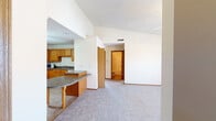Located at 2404 Heathrow Dr in Champaign, Illinois, this single-story home offers a well-organized open-concept layout that connects the main living areas seamlessly. The living room is a standout space, featuring vaulted ceilings, a ceiling fan, a corner fireplace, and a window that brings in natural light, all set over plush carpeting that extends throughout the living and bedroom areas.

The kitchen is generously sized, equipped with warm oak cabinetry spanning the full perimeter, dark laminate countertops, a full suite of appliances including a range, refrigerator, and microwave, and tile flooring. A peninsula with a granite-toned surface and decorative legs serves as a natural divider between the kitchen and the open living and dining space, providing additional prep and seating area.

The bedrooms are carpeted and well-proportioned, each featuring ceiling fans and ample closet space, including at least one room with an open built-in closet system. The bathrooms include oak vanity cabinetry, a mirror medicine cabinet, and a tub-shower combination with tile flooring. A dedicated laundry area with washer and dryer hookups adds everyday convenience to this functional and cohesive single-floor home.