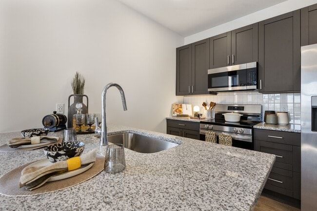 Modern apartment kitchen with island at Montage West Lafayette. - Montage West Lafayette