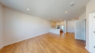 Located on the third floor at 35 Spring St in Wallington, NJ, Unit 304 is a thoughtfully designed one-bedroom, one-bathroom residence that makes efficient use of its space. The open-concept living area flows seamlessly from the dining space into a well-appointed kitchen, which features crisp white shaker-style cabinetry extending to the ceiling for generous storage, a white quartz peninsula countertop, stainless steel appliances including a gas range, microwave, and refrigerator, and recessed lighting throughout. Warm hardwood-style flooring runs continuously across the unit, lending a cohesive and inviting feel. The bedroom is a comfortable, light-filled room with a large window offering neighborhood views and a wall-mounted HVAC unit for individual climate control. Three closets, including a spacious walk-in with wire shelving, provide ample storage. The bathroom is elegantly finished with a soaking tub and floor-to-ceiling marble-patterned tile surround, complemented by a white vanity and wood-look tile flooring. Recessed lighting and a clean, neutral white palette throughout the unit create a bright, modern ambiance that is both functional and visually appealing.