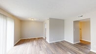 Located at 697 Outer Belle Rd in Trotwood, Ohio, this single-floor, three-bedroom, two-bathroom home offers a practical and well-maintained layout. The open living area features light wood-look flooring, neutral-toned walls, and a textured ceiling, creating a bright and clean atmosphere throughout. A half-wall partition adds subtle definition between living spaces while maintaining an open feel.

The galley-style kitchen is a standout feature, outfitted with white shaker cabinetry, marble-look countertops, a double-basin stainless steel sink, and stainless steel appliances including a refrigerator and range. Wood-look flooring continues through the kitchen, which connects seamlessly to the hallway and entry.

Three carpeted bedrooms provide comfortable retreats, each with neutral walls, textured ceilings, and windows that allow natural light to filter in. The primary bedroom offers a generous footprint ideal for a full bedroom suite.

The two bathrooms are finished with clean white vanities, wood-look tile flooring, and tiled shower surrounds with chrome fixtures, reflecting a consistent, updated aesthetic. Multiple hallways connect the rooms efficiently, contributing to a well-organized floor plan. Overall, this home presents a move-in ready, refreshed interior with cohesive finishes throughout.