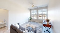 This contemporary 830 square foot apartment in Cedar Rapids, Iowa, offers a harmonious blend of style and functionality. The open-concept design seamlessly integrates the kitchen and living areas, creating a spacious feel. The kitchen boasts white cabinetry, stainless steel appliances, and a large island with a sink, perfect for both meal preparation and casual dining.

The living room features large windows that flood the space with natural light and provide city views. Neutral tones dominate the color palette, creating a calm and inviting atmosphere. The bedroom, measuring 130 square feet, offers ample space and includes a walk-in closet for storage. The bathroom is modern and efficient, with a single vanity and a shower/tub combination.

A notable feature is the in-unit laundry room, equipped with a stacked washer and dryer, and additional shelving for storage. Throughout the apartment, wood-look flooring adds warmth and durability. The overall design emphasizes clean lines and a minimalist aesthetic, making it an ideal space for contemporary urban living.