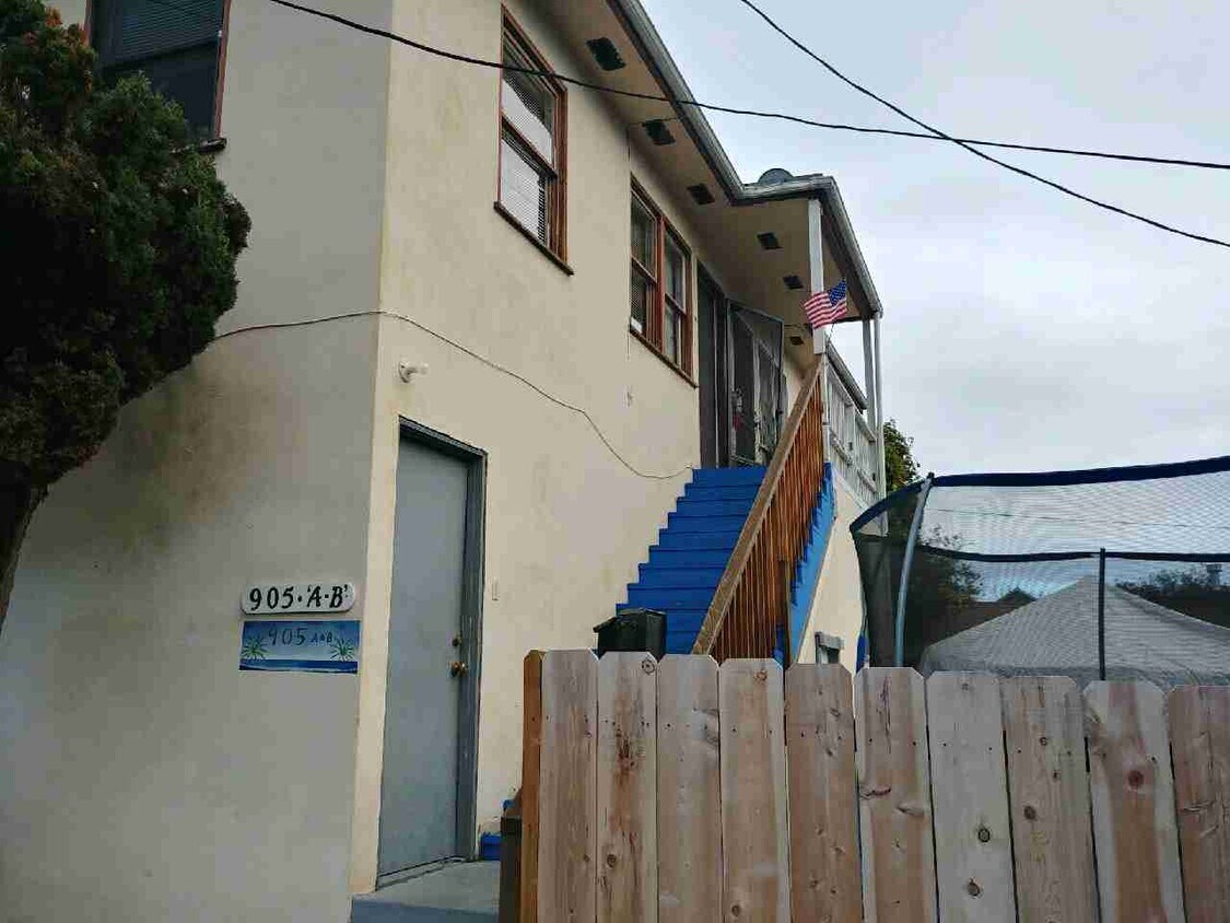stairway to apartment & door to garage - 905 Seagaze Dr