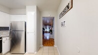 This 2-bedroom, 2-bathroom apartment at Briar Court Apartments in Houston, TX offers a thoughtfully designed single-floor layout with a comfortable and functional living space. Warm hardwood flooring flows throughout the main living areas and bedrooms, creating a cohesive and inviting atmosphere.

The living room serves as the heart of the home, highlighted by a classic white brick fireplace with a mirrored surround that adds depth and character to the space. Natural light enters through large windows dressed with blinds. The adjacent dining area features a striking mirrored wall that enhances the sense of openness, creating an elegant and airy setting for meals.

The kitchen is well-appointed with white cabinetry, granite countertops, a grey subway tile backsplash, and stainless steel appliances, including a range and refrigerator. Light tile flooring completes the clean, modern aesthetic.

Both bedrooms are comfortably sized, with the primary bedroom offering a ceiling fan, a window for natural light, and ample floor space. Each bedroom provides access to closet storage. The two bathrooms are finished with granite-topped vanities and tile flooring; one includes a tub-shower combination.

A connecting hallway links all rooms efficiently, and the overall layout makes excellent use of the available space throughout this well-maintained Houston apartment.