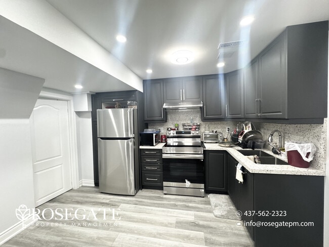 Building Photo - Bright 1 Bedroom + Den (Usable as 2nd Bedroom) Basement Apartment with Parking