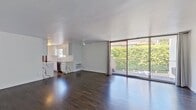 Located at 8440 Fountain Ave in West Hollywood, CA, this 970-square-foot apartment offers 2 bedrooms and 2 bathrooms across a single floor. Dark hardwood flooring flows consistently throughout the unit, creating a cohesive and modern aesthetic against crisp white walls. The galley-style kitchen is well-appointed with white shaker cabinets, striking marble-look quartz countertops, stainless steel appliances, and a window that brings in natural light. The living room features a ceiling fan and large sliding glass doors that open onto a private balcony overlooking lush greenery, filling the space with abundant natural light. The primary bedroom spans 210 square feet and includes mirrored sliding closet doors and a ceiling fan. The second bedroom offers a ceiling fan, a wall AC unit, and a sizable window with open sky views. Both bathrooms are cleanly finished in white — one features a glass-enclosed walk-in shower with white subway tile and a quartz vanity, while the other includes a full soaking tub with matching white tile surround. A connecting hallway ties all rooms together efficiently. Ceiling fans throughout and multiple wall AC units ensure year-round comfort in this move-in-ready West Hollywood residence.