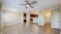 Located at 5462 Whittlesey Blvd in Columbus, Georgia, this two-story home offers a thoughtfully designed layout across two floors. The entry-level garage provides convenient direct interior access and includes overhead storage racks and an automatic opener. A staircase leads to the main living floor, where the open-concept kitchen and living room serve as the heart of the home. The kitchen is well-equipped with rich walnut-toned cabinetry, granite countertops, a granite-topped peninsula with pendant lighting, a classic subway tile backsplash, and a full suite of stainless steel appliances including a refrigerator, range, microwave, and dishwasher — all set on clean tile flooring. The living area flows seamlessly from the kitchen and features light wood-look flooring, crown molding, and a ceiling fan, with access to natural light through window treatments. The spacious bedroom is carpeted and bright, featuring multiple windows with blinds, a ceiling fan, and access to a dedicated closet. The full bathroom is finished with tile flooring, a granite vanity, and a tiled soaking tub/shower combination. A separate laundry area and hallway complete the upper floor, rounding out this efficient and comfortable home.