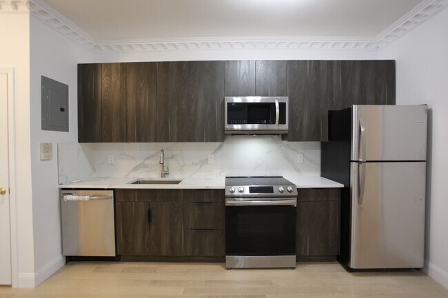 New Kitchen with stainless appliances including dishwasher, electric stove range - 35-25 Crescent St