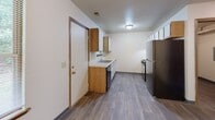 Located at 160 Bridgewood Dr in Battle Creek, Michigan, this two-story home offers three bedrooms and three bathrooms spread evenly across two floors. The layout provides a practical and functional living environment suited for a variety of occupants.

The kitchen features wood-toned cabinetry paired with white lower cabinets and light countertops, a stainless steel double sink, a dishwasher, and a refrigerator. Wood-look vinyl flooring runs throughout, and a window above the sink allows natural light to fill the space.

The bedrooms are carpeted and finished with neutral walls and warm wood-toned baseboards and trim. Each room offers a clean, open layout, and select bedrooms include closets with wire shelving for organized storage. Windows provide natural light and views of the surrounding area.

The three bathrooms are consistently appointed with vanities, mirrors, and tub-shower combinations. Wood-look vinyl flooring and light-toned walls maintain a cohesive feel throughout. One bathroom features a window for added ventilation and natural light.

A dedicated laundry room includes washer and dryer hookups and houses the water heater, keeping utilities conveniently consolidated. Two staircases connect the floors, supporting efficient circulation throughout the home. Overall, the space presents a straightforward, functional layout with consistent finishes across all rooms.