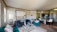 This single-story, two-bedroom, two-bathroom residence in Spring, Texas offers a thoughtfully designed layout with contemporary finishes and a cohesive neutral color palette throughout. Crown molding and tile flooring define the open-concept living area, which features multiple windows that invite natural light and offer views of surrounding greenery. The space flows naturally into a dedicated dining area, also brightened by a window with outdoor views.

The kitchen is well-equipped with rich dark wood cabinetry, granite countertops, a mosaic tile backsplash, stainless steel appliances, and a breakfast bar that connects seamlessly to the main living space. An arched passageway adds an architectural detail that enhances the overall design.

Both bedrooms are carpeted and include ceiling fans. The primary bedroom is notably spacious, while the secondary bedroom features a window with natural light. Each room offers a calm, restful ambiance. The bathrooms are clean and functional, with one featuring a soaking tub with a curved shower rod and white tile surround.

Overall, the residence presents a balanced combination of practical layout, quality finishes, and comfortable living spaces suited for everyday living in the Spring, TX area.