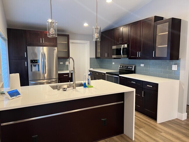 Kitchen, quartz countertops, waterfall sides - 10961 SW 11th Pl