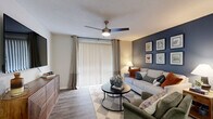 Located at 122 Riverstone Ct in Easley, SC, this thoughtfully designed single-floor home offers 2 bedrooms, 2 bathrooms, two dedicated office spaces, and a full in-unit laundry room. The open-concept living, dining, and kitchen area serves as the heart of the home, with wood-look flooring flowing throughout. The living room features a ceiling fan, a bold navy accent wall, and a sliding glass door with vertical blinds that invites natural light. The adjacent dining area provides a defined space for meals, while the kitchen impresses with white shaker cabinetry, granite countertops, a classic subway tile backsplash, stainless steel appliances, and a skylight that brightens the space. Both bathrooms are finished with granite-topped white vanities and tub-shower combinations. The primary bedroom includes plush carpet, a ceiling fan, a generous closet, and a window with outdoor views. Two separate office spaces offer flexibility for working from home or additional living needs. Five closets throughout the home ensure ample storage. The dedicated laundry room houses a full-size washer and dryer. This home combines functional layout with clean, modern finishes throughout.