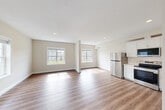 Located at 5 Eagle Brook Blvd in Wrentham, MA, this well-appointed three-bedroom, three-bathroom home spans three floors, offering a thoughtful layout with generous living space throughout. The attached garage on the ground level provides convenient interior access and includes an automatic opener and electrical panel. An unfinished basement offers excellent storage or future finishing potential, with visible insulation and utility infrastructure already in place. The main living floor features an open-concept kitchen and living area finished with warm hardwood-style flooring. The kitchen is outfitted with crisp white shaker cabinetry, light countertops, a stainless steel dishwasher, and an undermount sink — delivering a clean, modern aesthetic. Large windows flood the living area with natural light and offer views of the surrounding neighborhood and green landscape. The upper floor hosts the bedrooms, including a spacious primary suite with plush carpeting, a walk-in closet featuring dual hanging rods, and its own bathroom. Additional bedrooms are well-proportioned with carpet flooring and bright windows. Three full bathrooms, including clean tub/shower combinations, serve the home's occupants comfortably. A dedicated laundry area and multiple hallways complete this functional and well-designed home.