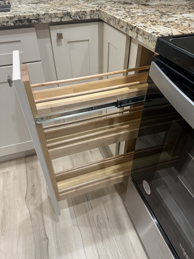 Spice rack in kitchen cabinet - Woodglen Terrace Apartments