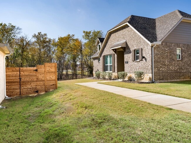A private side yard and dedicated entry add separation and ease, offering a quiet approach to daily living within this single-family cottage. - Amavi Celina