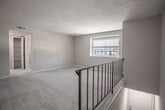 Located at 5643 Curry Cir in Virginia Beach, VA, this single-floor residence offers a thoughtfully arranged layout supported by clean, neutral finishes throughout. The living area is generously sized, featuring plush wall-to-wall carpeting, a ceiling fan with integrated lighting, and sliding glass doors that open to a private balcony, allowing natural light to flow into the space and providing pleasant outdoor views.

The kitchen is well-appointed with white shaker-style cabinetry, marble-look countertops, and stainless steel appliances including a range, refrigerator, and dishwasher. Wood-look flooring grounds the kitchen space, and a pass-through counter connects it conveniently to the living area.

The bedrooms are carpeted and comfortably sized, each featuring ceiling fans or ample overhead lighting. Closets with built-in shelving and hanging rods provide practical storage. One bedroom offers a walk-in style closet configuration, while others include standard reach-in closets.

The bathrooms are finished in a clean, white palette. One full bathroom features a tub-shower combination, wood-look flooring, and a white vanity with ample cabinetry. A second bathroom includes a single-sink vanity with a large mirror and brushed nickel fixtures. The overall ambiance of the space is bright, neutral, and move-in ready.
