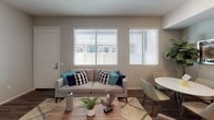 This single-story model unit at 48-150 E 31st Street in National City presents a thoughtfully designed floor plan with a cohesive blend of modern finishes and functional living spaces. Wood-style flooring runs throughout, providing a warm and consistent aesthetic across every room.

The open-concept living and dining area is anchored by large windows fitted with horizontal blinds, allowing abundant natural light to fill the space. The layout flows naturally into a well-appointed kitchen featuring dark espresso cabinetry, granite-style countertops, and a full suite of stainless steel appliances including a gas range, microwave, dishwasher, and refrigerator. Ample upper and lower cabinetry provides generous storage.

Two bedrooms offer comfortable retreats, each with wood-style flooring, closet storage, and soft neutral tones. One bedroom includes sliding glass doors opening to an outdoor area, enhancing the sense of space and providing direct access to natural light and fresh air.

Both bathrooms are finished with dark vanity cabinetry, wood-style flooring, and full tub-shower combinations with tile surrounds, delivering a clean and practical design. The overall ambiance of the unit is modern, bright, and move-in ready.