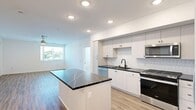 Located in Wildomar, CA, this single-story, 3-bedroom, 2-bathroom home offers a thoughtfully designed layout with modern finishes throughout. The open-concept kitchen and living area serves as the heart of the home, featuring white shaker cabinetry, dark quartz countertops with striking veining, a subway tile backsplash, and a full suite of stainless steel Whirlpool appliances including a gas range, over-the-range microwave, dishwasher, and side-by-side refrigerator. A central kitchen island provides additional prep space and adds to the sense of openness. Light wood-look flooring runs throughout the home, complementing the clean, white walls and recessed lighting. The living area benefits from natural light through a large window, with a ceiling fan adding comfort. The spacious primary bedroom includes its own window with outdoor views and a dedicated closet. The two bathrooms are clean and modern, each featuring white cabinetry, dark quartz vanity countertops, undermount sinks, and a shower-tub combination with tiled surrounds. The secondary bedrooms are bright and airy, each with windows offering natural light and views of the surrounding neighborhood. A hallway connects the living spaces efficiently, completing this well-appointed home.