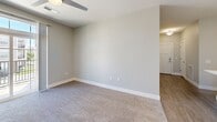 Located at 510 Morning Oaks Dr in Westfield, Indiana, this well-appointed 3-bedroom, 2-bathroom unit offers a thoughtfully designed single-floor layout with a clean, contemporary aesthetic. The kitchen serves as a true centerpiece, featuring gray shaker-style cabinetry, a white quartz center island with an integrated sink, stainless steel appliances including a refrigerator, range, and microwave, a classic white subway tile backsplash, and stylish pendant lighting — all set atop durable wood-look flooring. The spacious primary bedroom provides a generous footprint with plush carpeting, while a dedicated walk-in closet outfitted with wire shelving offers practical storage solutions. The two secondary bedrooms are similarly carpeted and include ceiling fans for added comfort. The primary bathroom features a glass-enclosed tile shower with large-format stone-look tile, a gray vanity, and wood-look flooring. The second bathroom includes a soaking tub with matching tile surround. An in-unit laundry room with a washer and dryer, wood-look flooring, and a water heater adds everyday convenience. Neutral gray tones, white trim, and consistent finishes tie the entire space together for a cohesive, modern look.
