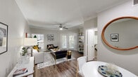 Located at 7700 N Capital of Texas Hwy in Austin, TX, this thoughtfully designed one-bedroom, one-bathroom residence offers a comfortable and stylish single-floor layout. An arched hallway entry with recessed lighting and rich hardwood-style flooring sets an inviting tone as you move through the space.

The living room is a standout feature, showcasing elegant crown molding, a ceiling fan, and large French doors that bathe the room in natural light and open to an outdoor view. The open layout flows seamlessly into the dining area, making it ideal for both relaxing and entertaining.

The kitchen is well-equipped with dark cabinetry and granite-style countertops, providing ample storage and prep space. The bedroom is a generously sized retreat, carpeted for comfort, and highlighted by a bay window configuration that allows for abundant natural light. A ceiling fan adds to the room's comfort, and a dedicated closet provides convenient storage.

The bathroom features a tub-shower combination, dark wood cabinetry, granite countertops, and hardwood-style flooring, offering a clean and functional design. Throughout the residence, neutral tones, quality finishes, and consistent design choices create a cohesive and welcoming ambiance suited for modern Austin living.
