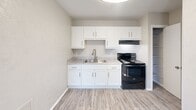 Located at 1840 Killingsworth Rd in Augusta, Georgia, this one-bedroom, one-bathroom unit offers an efficient and well-organized single-floor layout. The open living area features light-toned luxury vinyl plank flooring that extends throughout the main living and kitchen spaces, creating a cohesive and easy-to-maintain foundation.

The kitchen is thoughtfully appointed with crisp white shaker-style cabinetry extending to the upper walls, offering generous storage. A double-basin sink with a modern pull-down faucet is paired with light granite-look countertops, and the space is equipped with a black electric range and matching refrigerator. A ventilation hood above the range adds functional utility.

The bedroom is a comfortable, well-proportioned retreat with plush carpeting, neutral walls, and a ceiling fan with integrated lighting. A window with blinds allows for natural light and ventilation. The room provides direct access to a dedicated closet as well as the bathroom, which features a full tub-shower combination with clean white subway-style tile surround and chrome fixtures.

The unit's neutral color palette, textured ceilings, and consistent finishes throughout contribute to a clean, move-in-ready ambiance suitable for a range of lifestyles.
