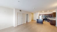 Located at 505 West 7th Street in New Castle, Delaware, this 2-bedroom, 1-bathroom unit offers a thoughtfully designed single-level layout. The open-concept kitchen and living area serves as the heart of the home, showcasing rich dark wood cabinetry, granite countertops, a decorative tile backsplash, stainless steel appliances, and a central island with pendant lighting overhead — ideal for both cooking and entertaining. Light wood-style flooring runs throughout the main living and kitchen areas, contributing to a clean, modern aesthetic.

The spacious living room benefits from natural light through large windows and offers a generous, versatile floor plan. The primary bedroom is notably roomy, featuring plush carpet, a ceiling fan, and ample space for a full furniture arrangement. The second bedroom also features light flooring, a ceiling fan, and a bright window. A dedicated closet provides useful storage.

The full bathroom is finished with large-format tile flooring, a tiled tub/shower combination, a granite-topped vanity with dark wood cabinetry, and a clean, neutral palette. The unit's neutral tones and consistent finishes throughout create a cohesive and move-in ready living environment.