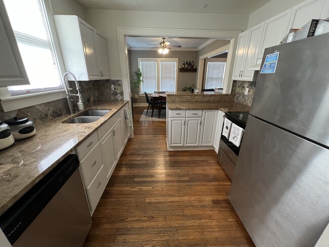 Kitchen includes stainless steel appliances, dishwasher, garbage disposal and a breakfast bar. - 14809 Leonard Ave