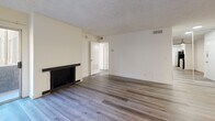 This contemporary 1-bedroom, 1-bathroom apartment in Los Angeles offers 650 square feet of efficiently designed living space. The interior showcases a cohesive design with modern wood-like flooring throughout, creating a seamless flow between rooms. The living area is spacious and bright, featuring a sliding glass door that leads to a private balcony, allowing natural light to flood the space. A sleek black fireplace serves as a focal point in the living room.

The kitchen is well-appointed with crisp white cabinetry, contrasting dark appliances, and a practical galley layout. The bedroom, measuring 170 square feet, is generously sized and includes a large mirrored closet, enhancing the sense of space. The bathroom is tastefully updated with a white vanity, modern fixtures, and a shower/tub combination.

High ceilings and recessed lighting contribute to the apartment's airy feel. The neutral color palette provides a blank canvas for personal decor. Located at 339 S Ardmore Ave, this apartment offers a blend of style and functionality in a prime Los Angeles location.