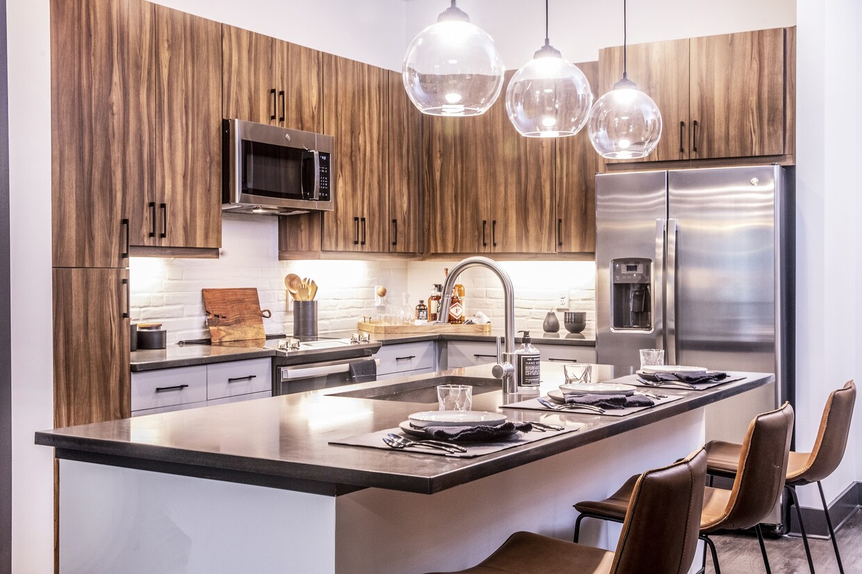 Our chef-inspired kitchens feature stainless steel appliances and side-by-side refrigerators. - Windsor Interlock