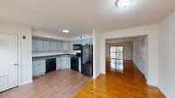 Located at 1 Reler Ln in Somerset, NJ, this single-floor residence offers three bedrooms and two bathrooms within a thoughtfully arranged floor plan. Warm-toned hardwood flooring runs consistently throughout the living areas and bedrooms, lending a cohesive and inviting character to the home.

The kitchen is well-appointed with light gray shaker-style cabinetry, dark countertops, and a full suite of black appliances including a gas range, dishwasher, microwave, and refrigerator. It opens directly to the living area, creating a connected and functional flow for everyday living. The living room benefits from natural light streaming through a large window, enhancing the brightness of the space.

The primary bedroom is generously sized and features direct access to a private balcony with outdoor views, along with a dedicated closet. The two additional bedrooms each include windows with natural light and polished hardwood floors, offering comfortable and versatile spaces. A hallway connects the bedroom wing to the main living areas.

The bathrooms are clean and functional, with one featuring a dark wood vanity, a medicine cabinet mirror, and patterned tile flooring. The layout is efficient, making excellent use of the available footprint. Overall, the home presents a bright, clean aesthetic with durable finishes throughout.