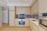 Located on the seventh floor at 1224 M St NW in Washington, DC, this modern one-bedroom, one-bathroom residence offers a thoughtfully designed layout with contemporary finishes throughout. Light maple hardwood flooring flows seamlessly across the entire unit, complementing the crisp white walls and recessed lighting that create a bright, airy atmosphere.

The open-plan living and dining area is bathed in natural light from floor-to-ceiling windows and a glass door that opens directly onto a private balcony, offering urban views of the surrounding Washington streetscape. The kitchen is well-appointed with light wood flat-front cabinetry, white quartz countertops, a decorative tile backsplash, and a full suite of stainless steel Bosch appliances including a gas range, wall oven, built-in microwave, and refrigerator.

The bedroom features large windows and a sliding glass door to an additional outdoor space, filling the room with sunlight. A built-in closet with sliding doors provides ample storage. The bathroom is elegantly finished with large-format marble-look tile flooring, a floating wood vanity, backlit mirror, and a full soaking tub with tiled surround. An in-unit laundry area and dedicated closet add everyday convenience to this polished urban residence.