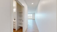 Located at 2240 Northwestern Ave in Racine, WI, this thoughtfully designed 2-bedroom, 1-bathroom unit offers a clean, contemporary aesthetic throughout its well-appointed single-floor layout. The open-concept kitchen and living area serves as the heart of the home, featuring crisp white cabinetry, a central island with a light countertop, stainless steel appliances including a refrigerator, range, microwave, and dishwasher, and stylish pendant lighting that adds a warm, modern touch. Light wood-style flooring flows seamlessly through the main living areas, enhancing the bright, airy atmosphere. The primary bedroom is a generously sized retreat filled with natural light from a large multi-pane window, while the second bedroom offers plush carpeting and its own window view. The shared bathroom is finished with a white vanity, black hardware accents, a mirror with overhead lighting, and convenient built-in shelving for added storage. A hallway linen closet provides additional organization. Throughout the unit, recessed lighting, clean white walls, and modern black hardware details create a cohesive and polished look. This move-in-ready unit combines functional design with contemporary finishes in a comfortable Racine location.